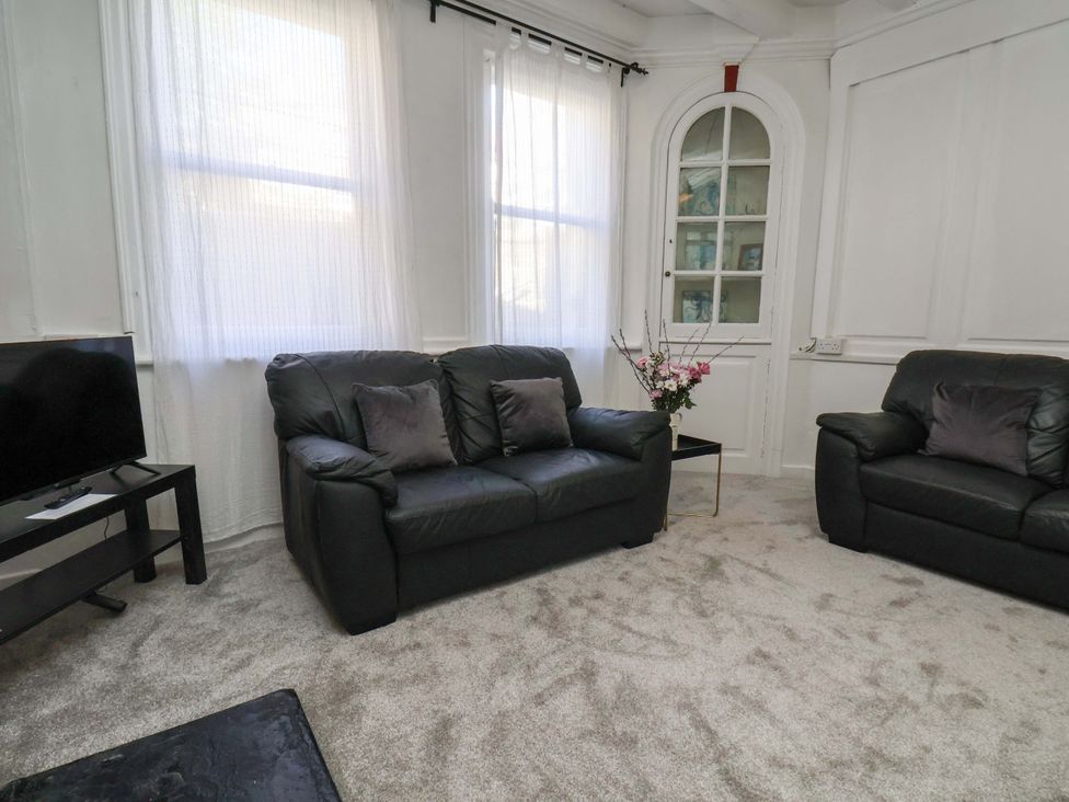 A living room with a sofa and television at The Anchorage in Whitby
