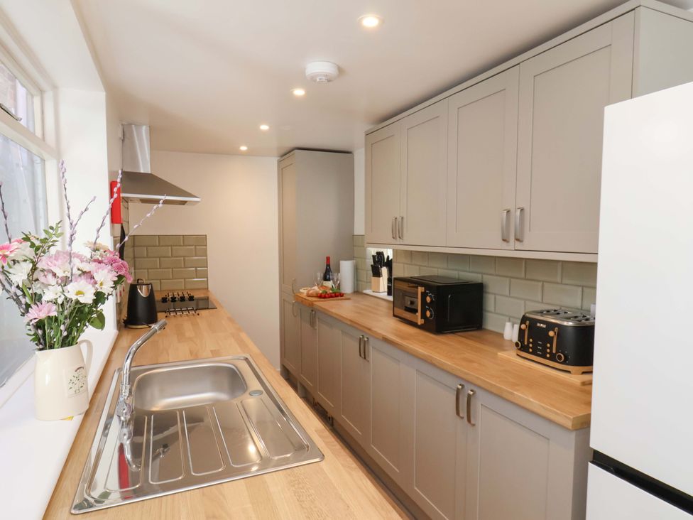 A kitchen with cabinets, sink, countertop and appliances at The Anchorage in Whitby