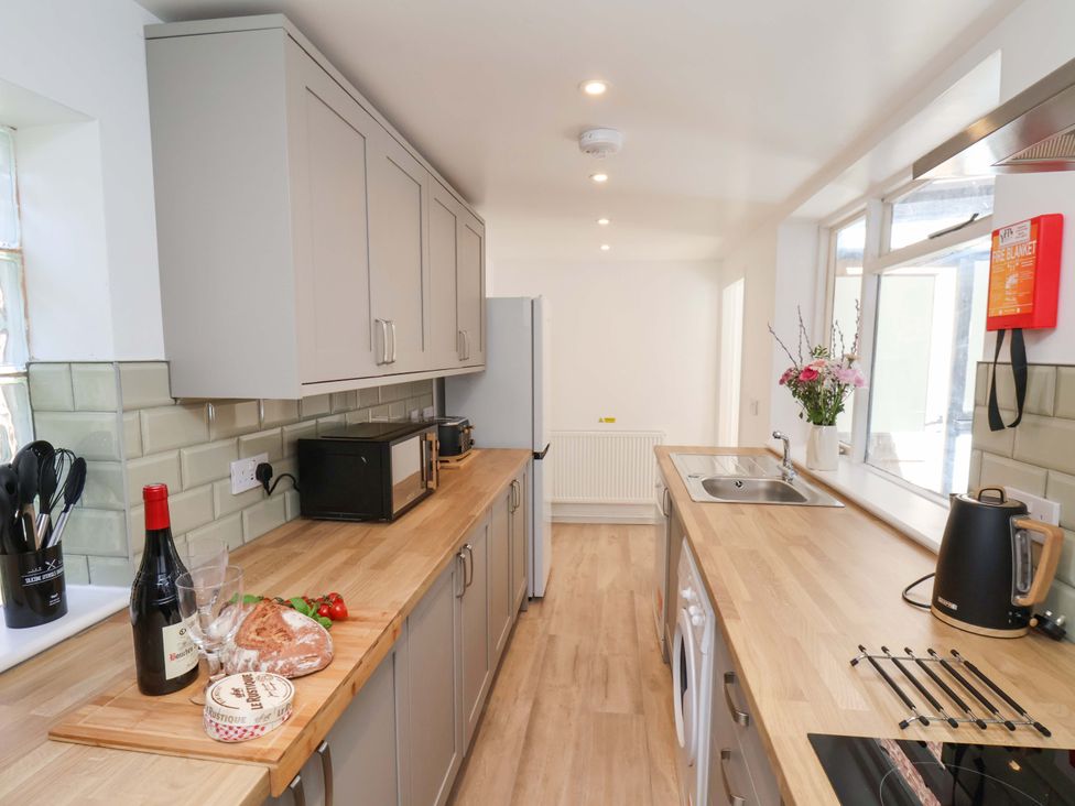 A kitchen with cabinets appliances and a cutting board at The Anchorage in Whitby