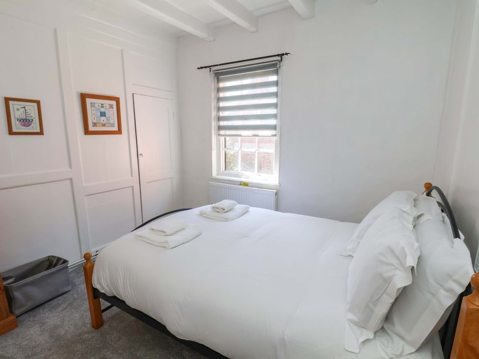 A bedroom with a bed and towels at The Anchorage in Whitby