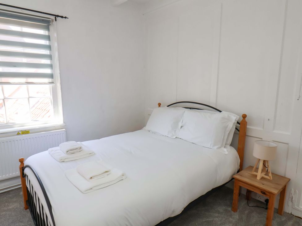 A bedroom with a bed and bedside table at The Anchorage in Whitby