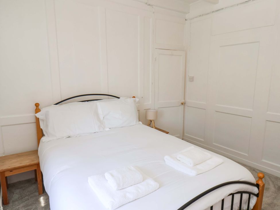 A bedroom with a bed and nightstand at The Anchorage in Whitby