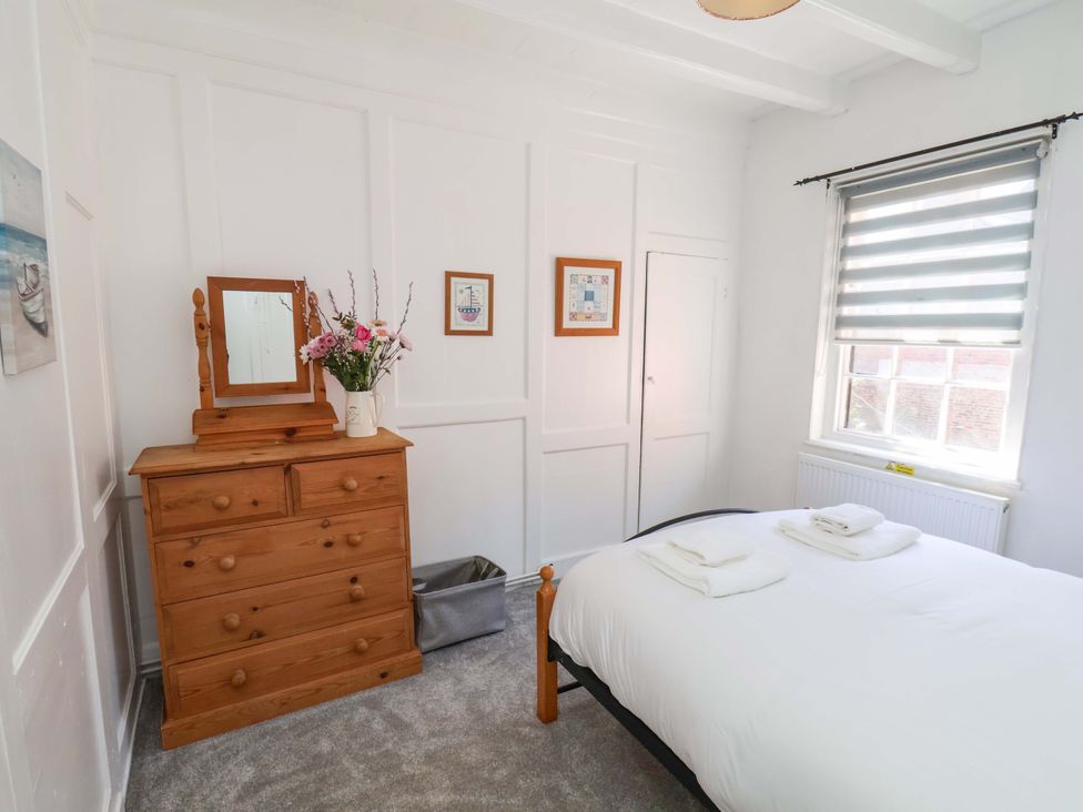 A bedroom with a bed and dressing table at The Anchorage in Whitby