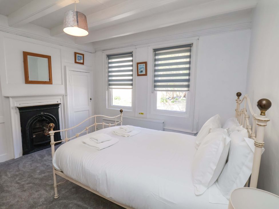 A bedroom with a bed and mirror at The Anchorage in Whitby