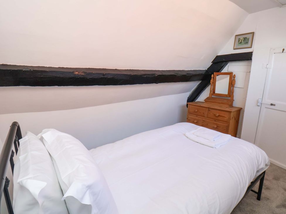 A bedroom with a bed and mirror at The Anchorage in Whitby