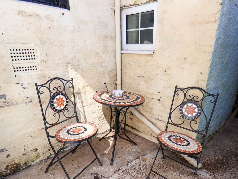 A table and two chairs in an outdoor area at The Anchorage in Whitby
