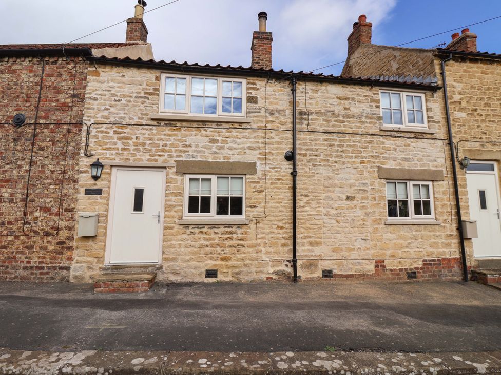 A stone cottage exterior with windows and a door at Dunning, The Mount in York