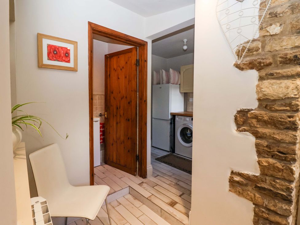 A kitchen area with appliances and a door at Dunning, The Mount in York
