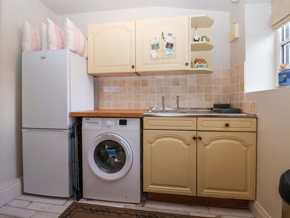 A laundry room with a refrigerator and washing machine at Dunning, The Mount, York