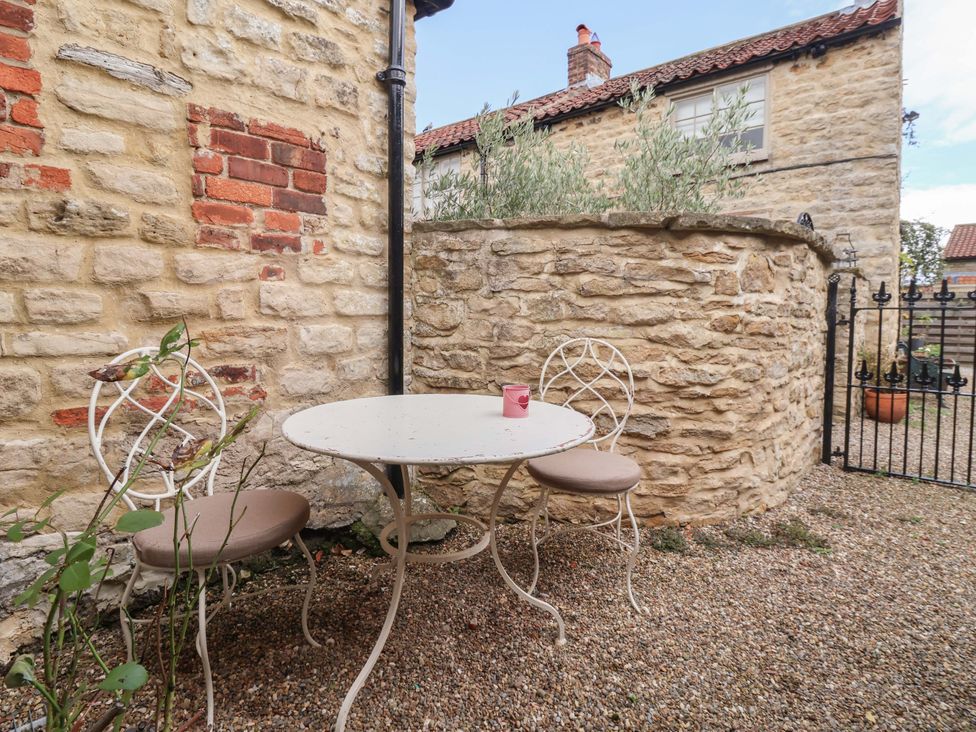 A garden area with a table and chairs at Dunning, The Mount in York