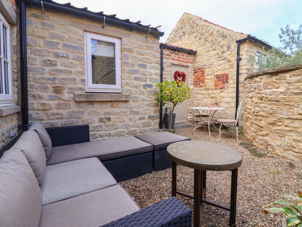 An outdoor seating area with a table and chairs at Dunning, The Mount in York