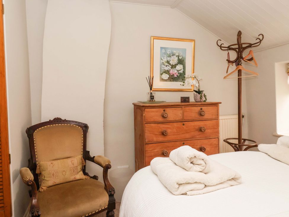 A bedroom with a dresser, bed, chair, and painting at Dunning, The Mount, York