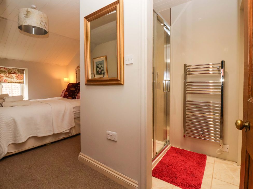 A bedroom with a bed, lamp, and attached bathroom at Dunning, The Mount, York