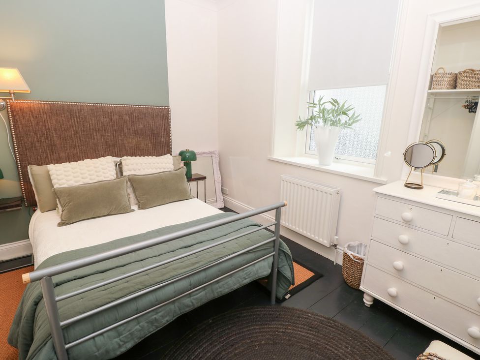 A bedroom with a bed and dresser at No. 5 Cliffview in Ventnor