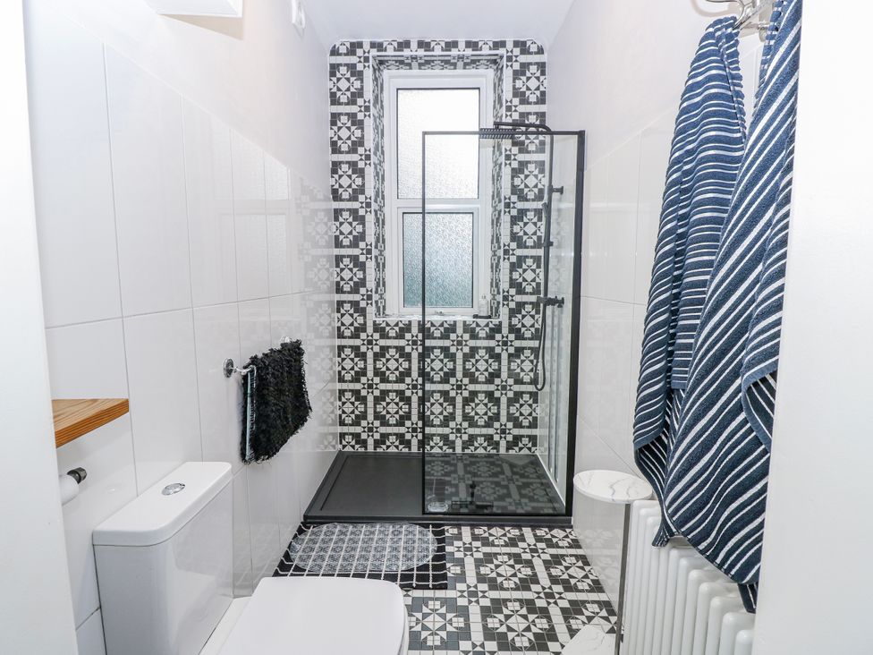 A bathroom with a shower and toilet at No. 5 Cliffview Ventnor