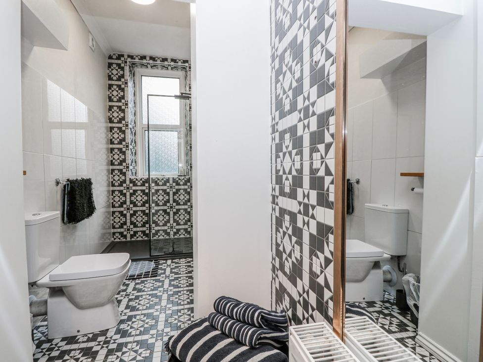 A bathroom with shower and toilet at No. 5 Cliffview Ventnor
