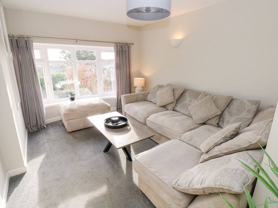 A living room with a sofa and coffee table at Westwinds in Tenby