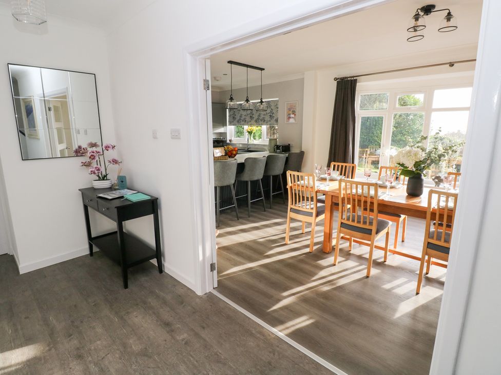 A dining room with table and chairs at Westwinds in Tenby