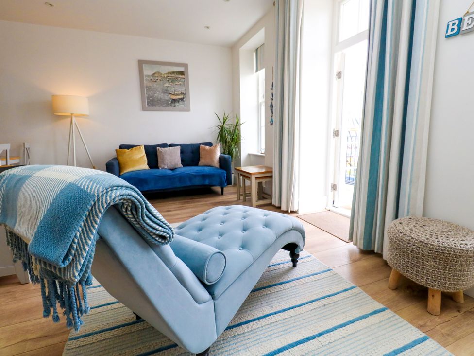 A living room with a chaise lounge and sofa at 4 The Beaches in Weymouth