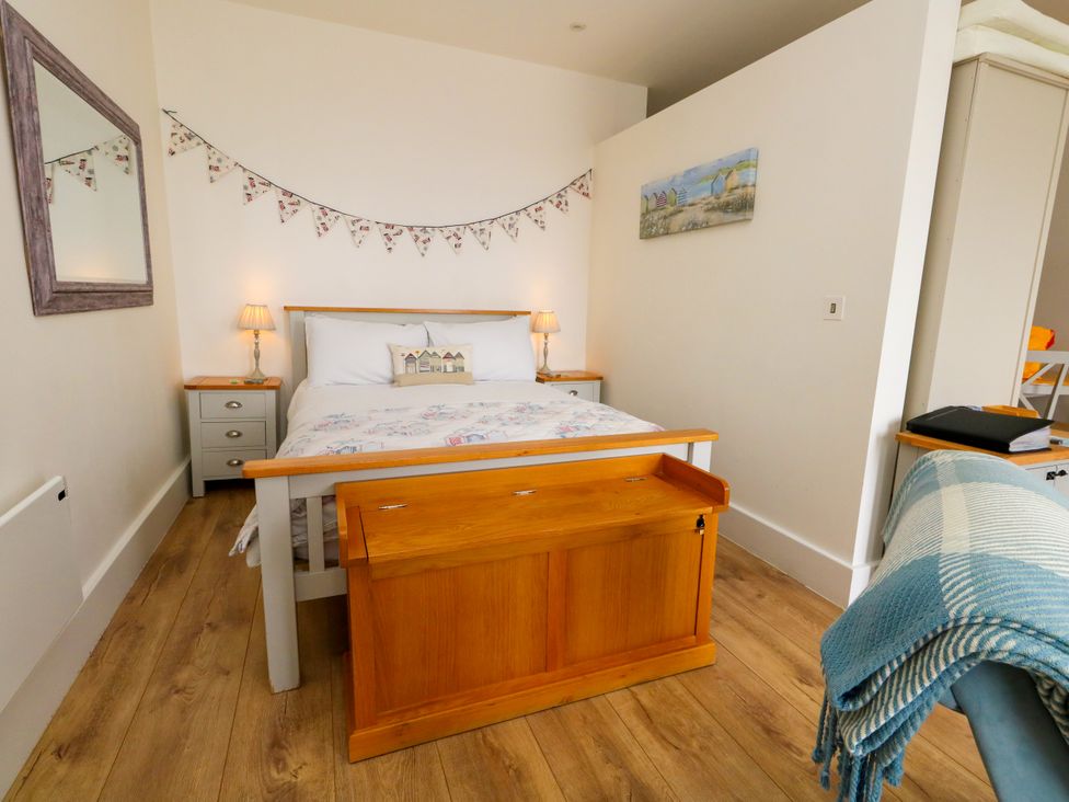 A bedroom with a bed and side tables at 4 The Beaches in Weymouth
