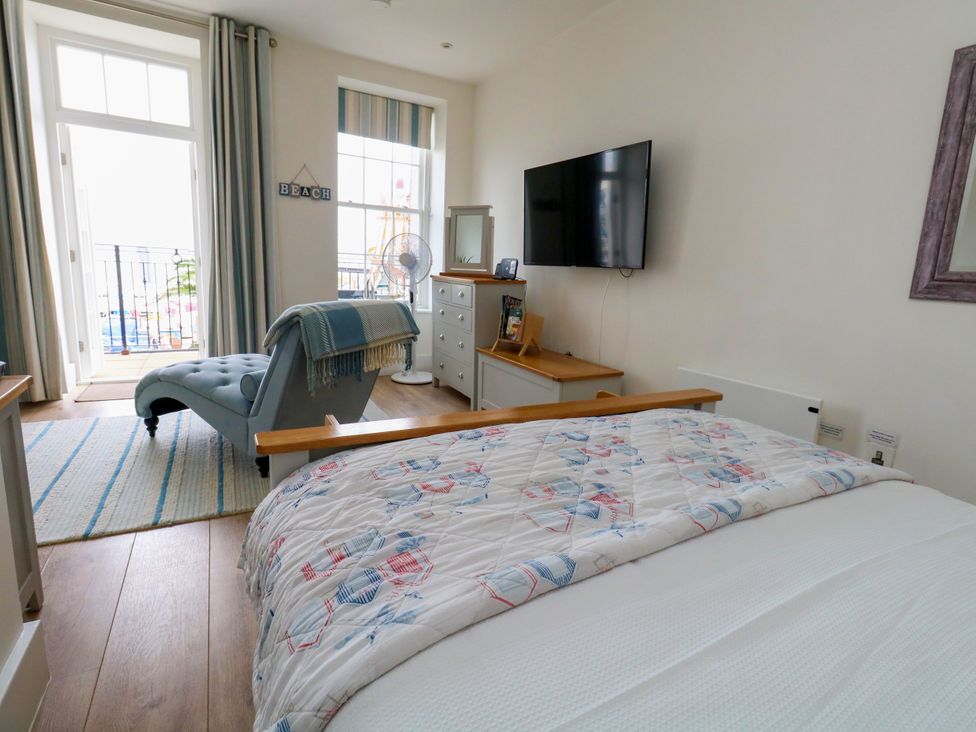 A bedroom with a bed and television at 4 The Beaches in Weymouth