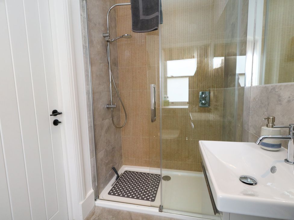 A bathroom with a shower and sink at 4 The Beaches Weymouth