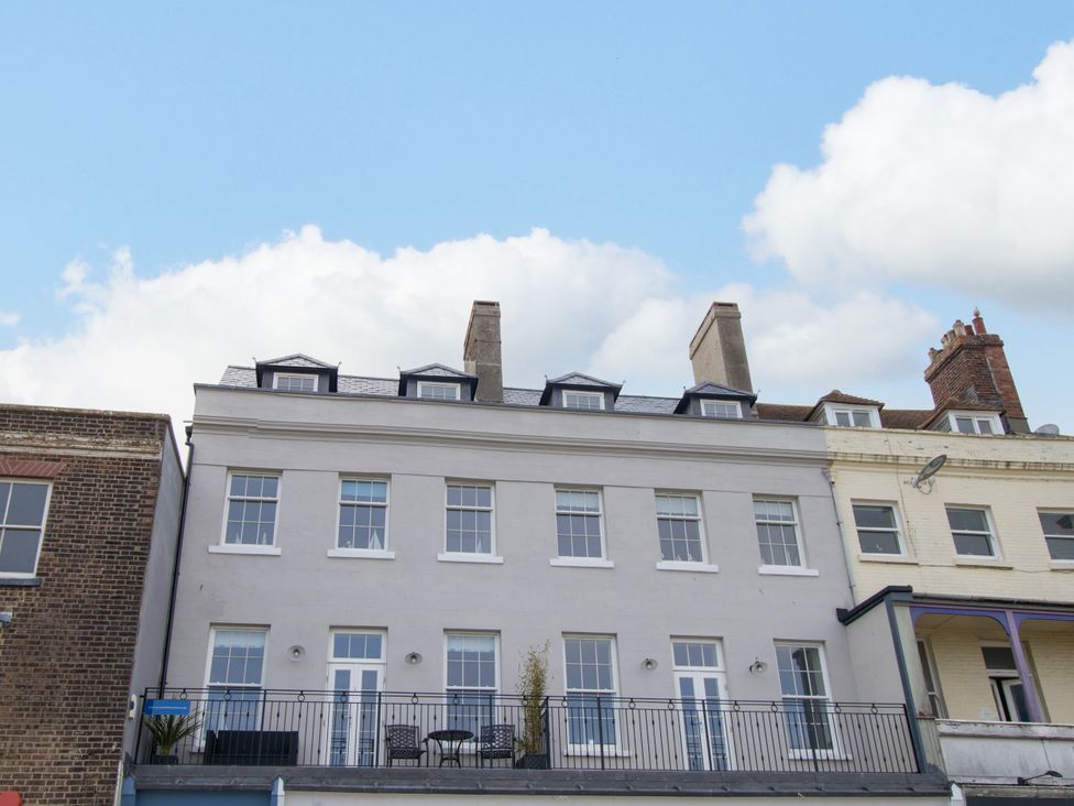 A building with a balcony and multiple windows at 4 The Beaches in Weymouth