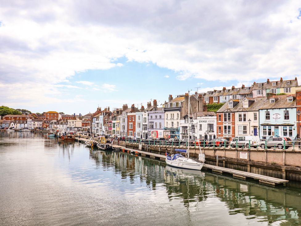 A waterfront view with buildings and boats at 4 The Beaches Weymouth