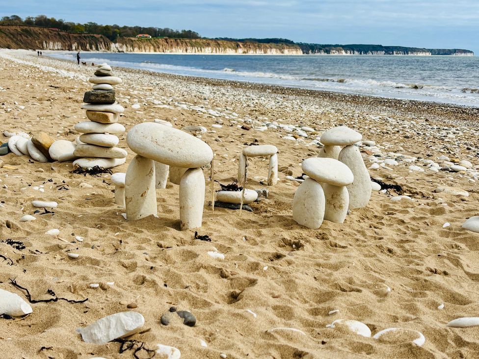Stone structures on a beach with a coastline and water in the background at Bobbies Retreat, 20 High Street, Bridlington