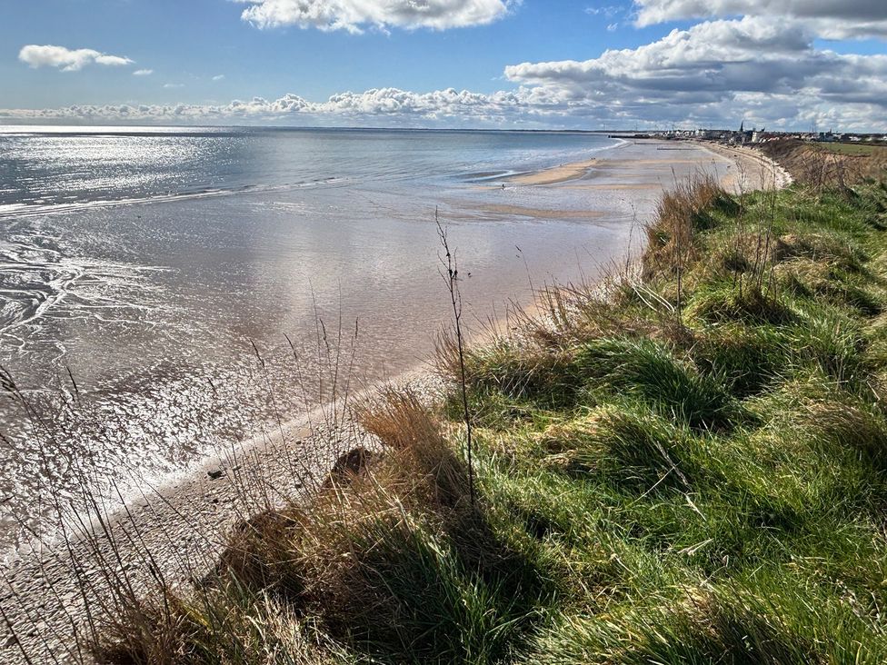 A beach view with water and grass at Bobbies' Retreat, 20 High Street Bridlington
