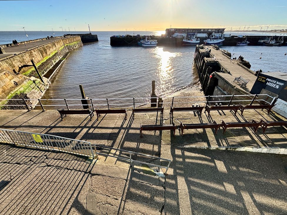 A view of a harbor with boats and a pier at Bobbies' Retreat, 20 High Street Bridlington