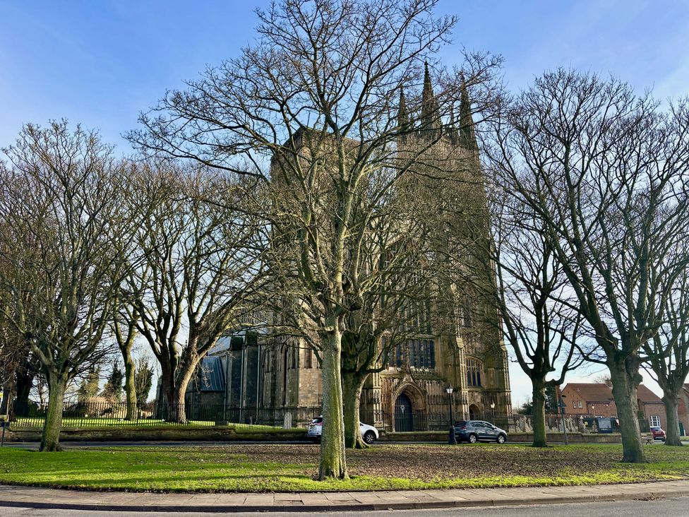 A church surrounded by trees and cars at Bobbies Retreat, 20 High Street, Bridlington