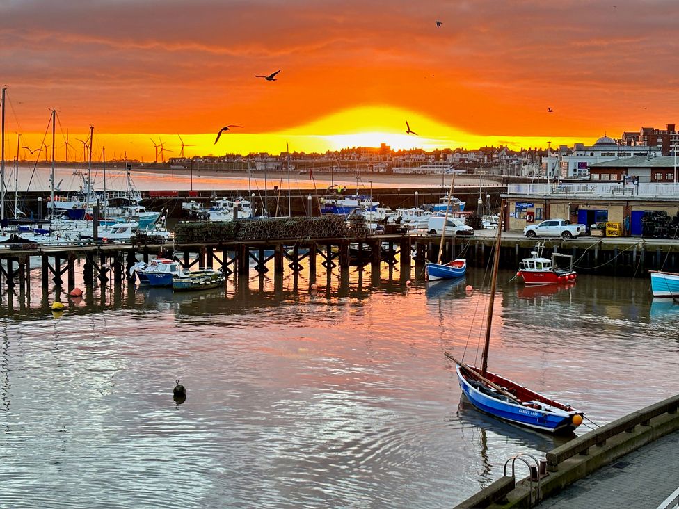 A marina with boats and sunset at Bobbies Retreat, 20 High Street, Bridlington
