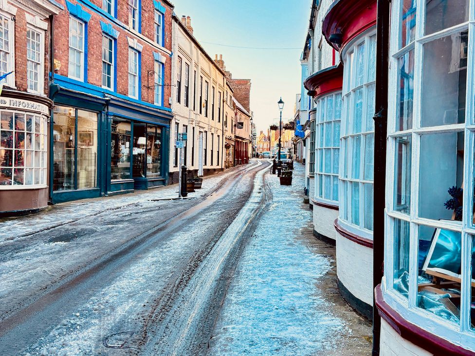 A street view with buildings and snow at Bobbies' Retreat, 20 High Street Bridlington