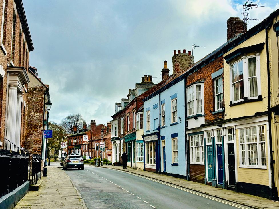 A street with houses and a parked car at Bobbies' Retreat, 20 High Street, Bridlington