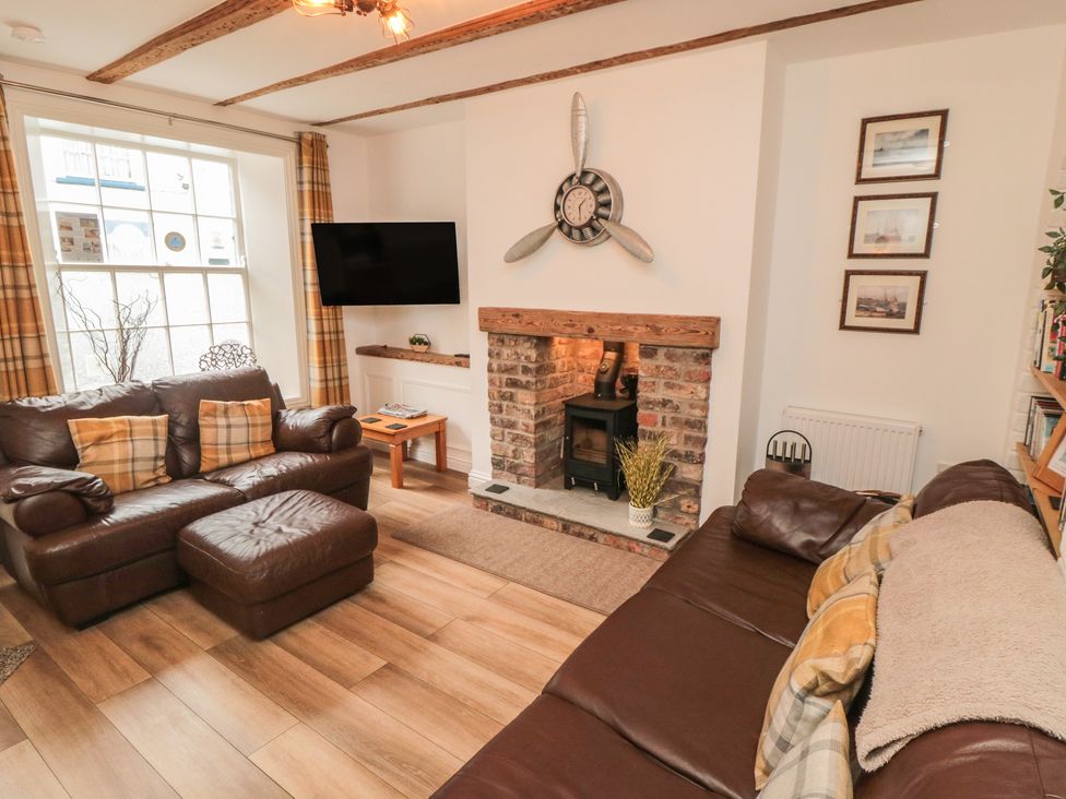 A living room with a sofa and television at Bobbies' Retreat, 20 High Street Bridlington