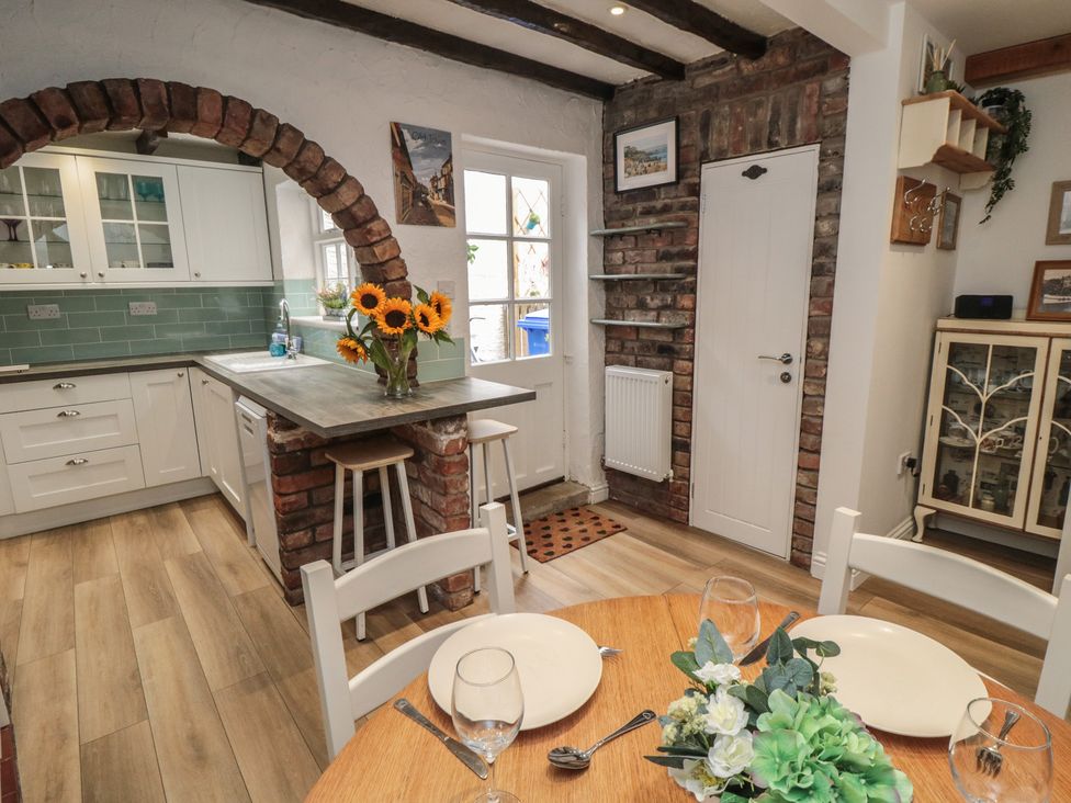 A kitchen with a table and chairs at Bobbies Retreat, 20 High Street in Bridlington