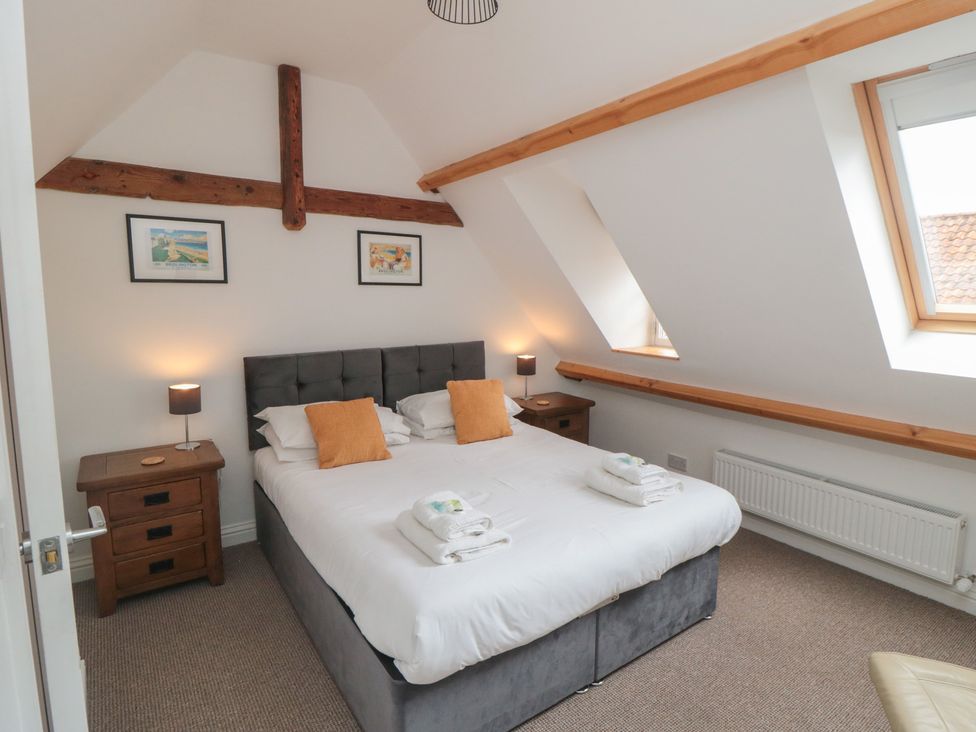 A bedroom with a double bed and bedside tables at Bobbies' Retreat, 20 High Street, Bridlington