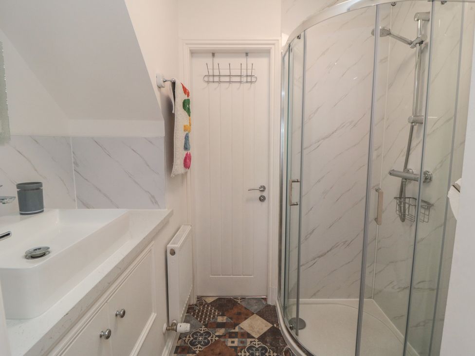 A bathroom with a shower and a sink at Bobbies' Retreat, 20 High Street, Bridlington