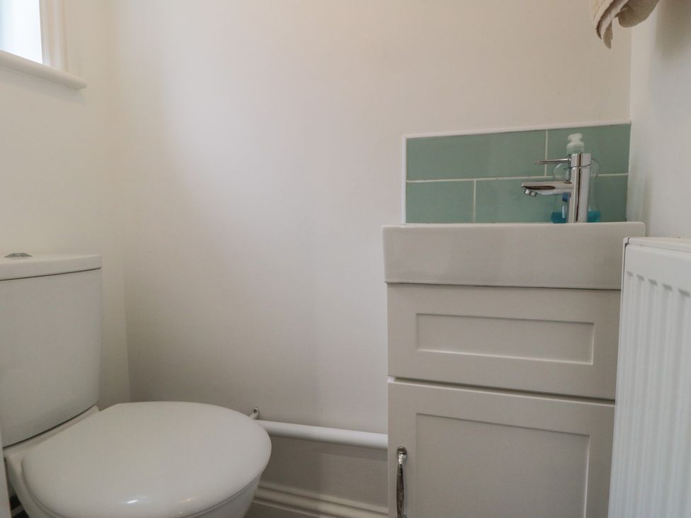 A bathroom with a toilet and sink at Bobbies Retreat, 20 High Street Bridlington