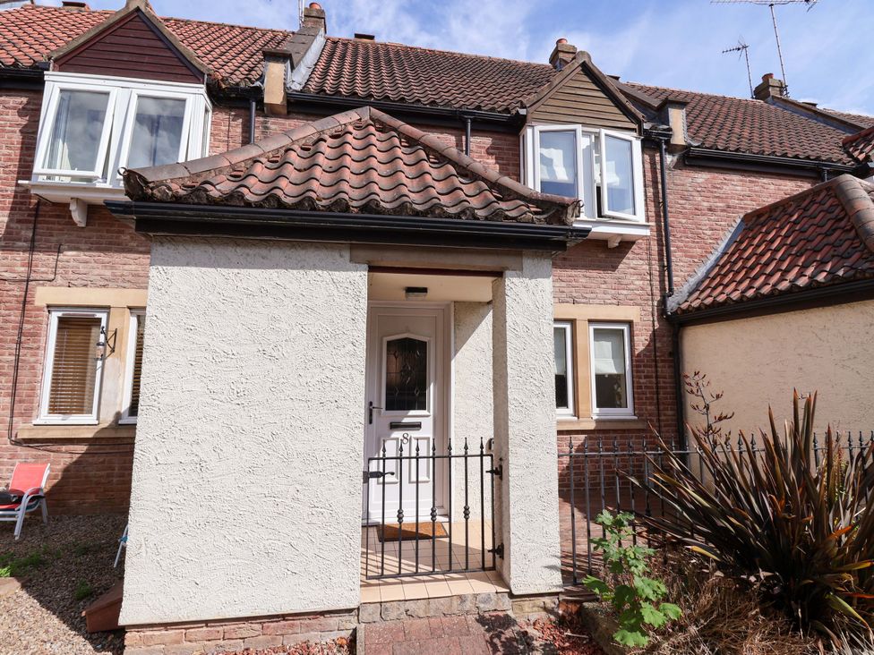 An entrance with a door and pathway at 8 Williamson Drive in Ripon