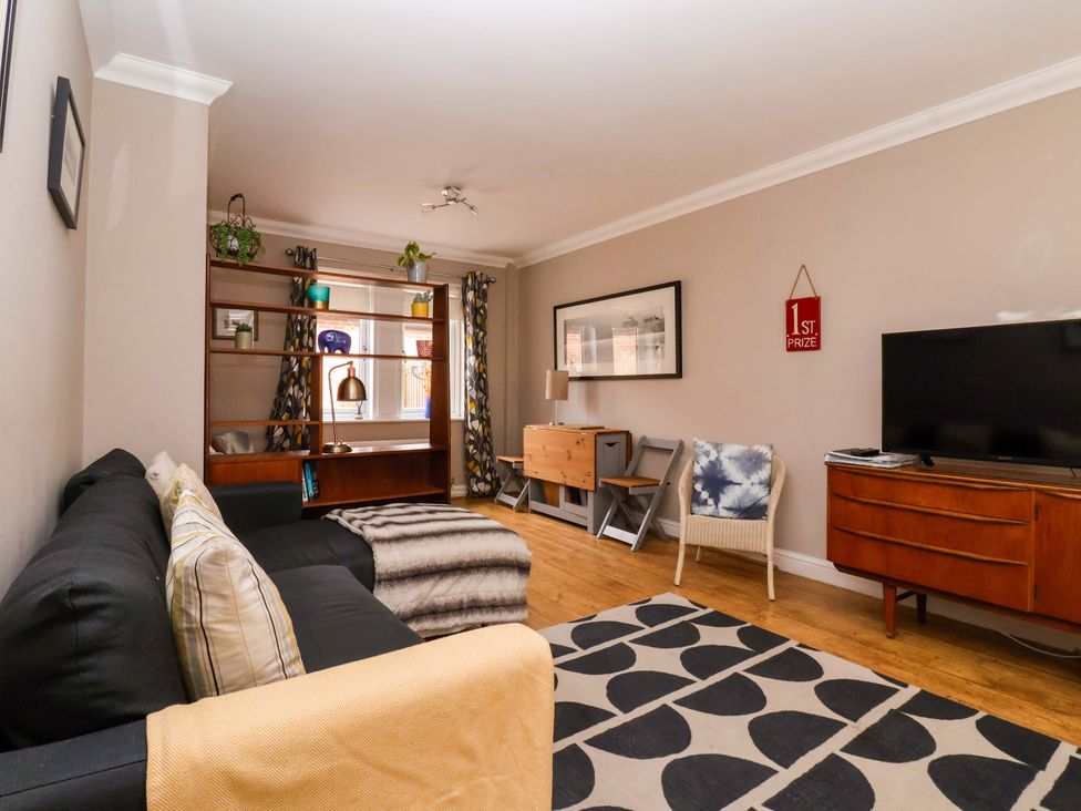 A living room with a sofa and television at 8 Williamson Drive Ripon