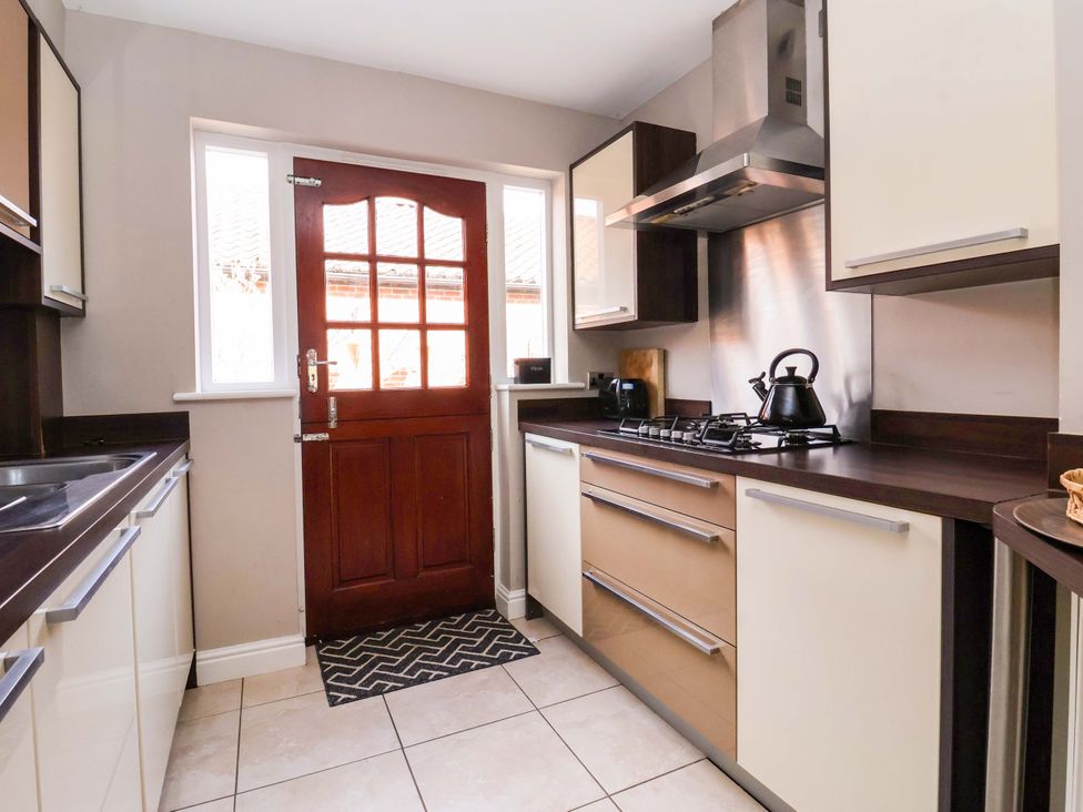 A kitchen with a door and window at 8 Williamson Drive in Ripon