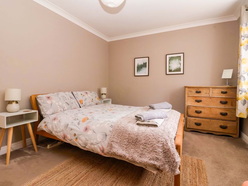 A bedroom with a bed and bedside table at 8 Williamson Drive in Ripon