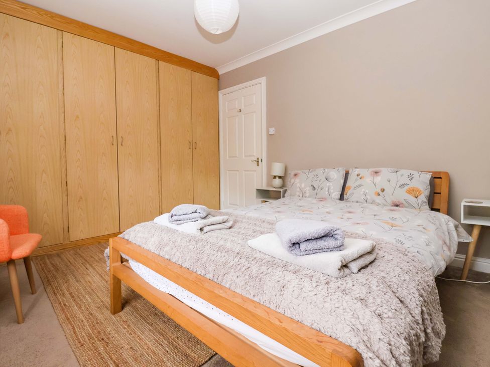 A bedroom with a bed and wardrobe at 8 Williamson Drive, Ripon