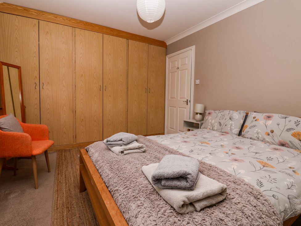 A bedroom with a bed and wardrobe at 8 Williamson Drive in Ripon