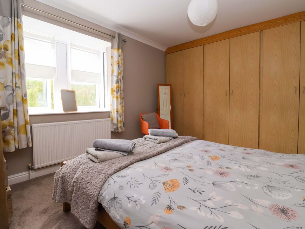 A bedroom with a bed and wardrobe at 8 Williamson Drive in Ripon