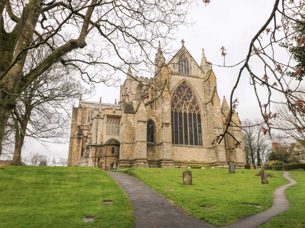 A church with trees and a pathway at 8 Williamson Drive in Ripon
