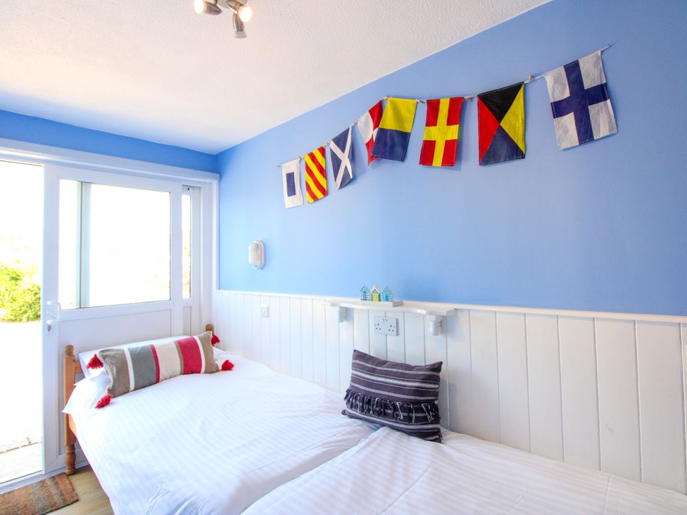 A bedroom with two beds and flag decorations at Merlin in Malborough