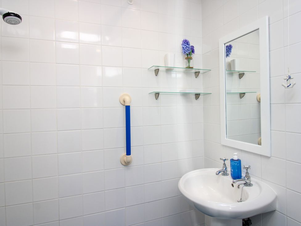 A bathroom with a sink and mirror at Merlin in Malborough